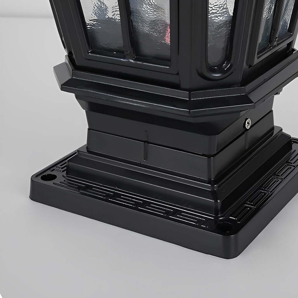 Close up of black stone pillar light fixture base showing mounting holes and solid construction.