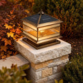 Stone pillar solar lights installed on a garden column with warm illumination at dusk.