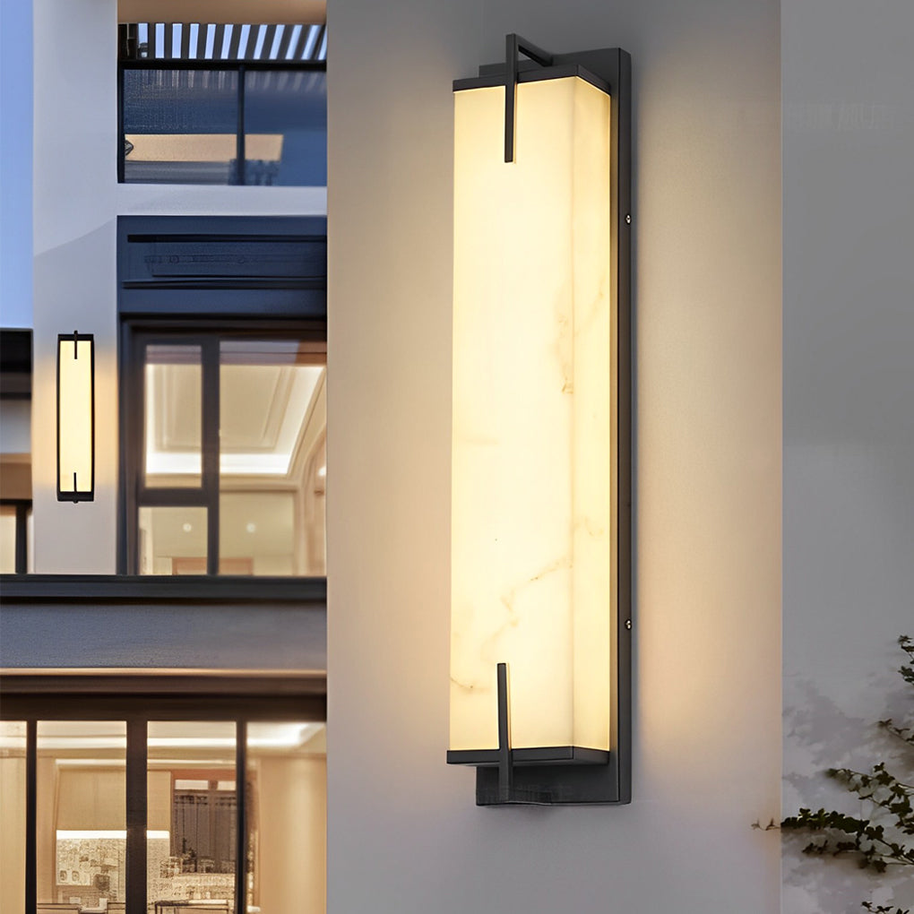 Stone wall sconce lighting illuminating a modern building facade, adding a touch of elegance.