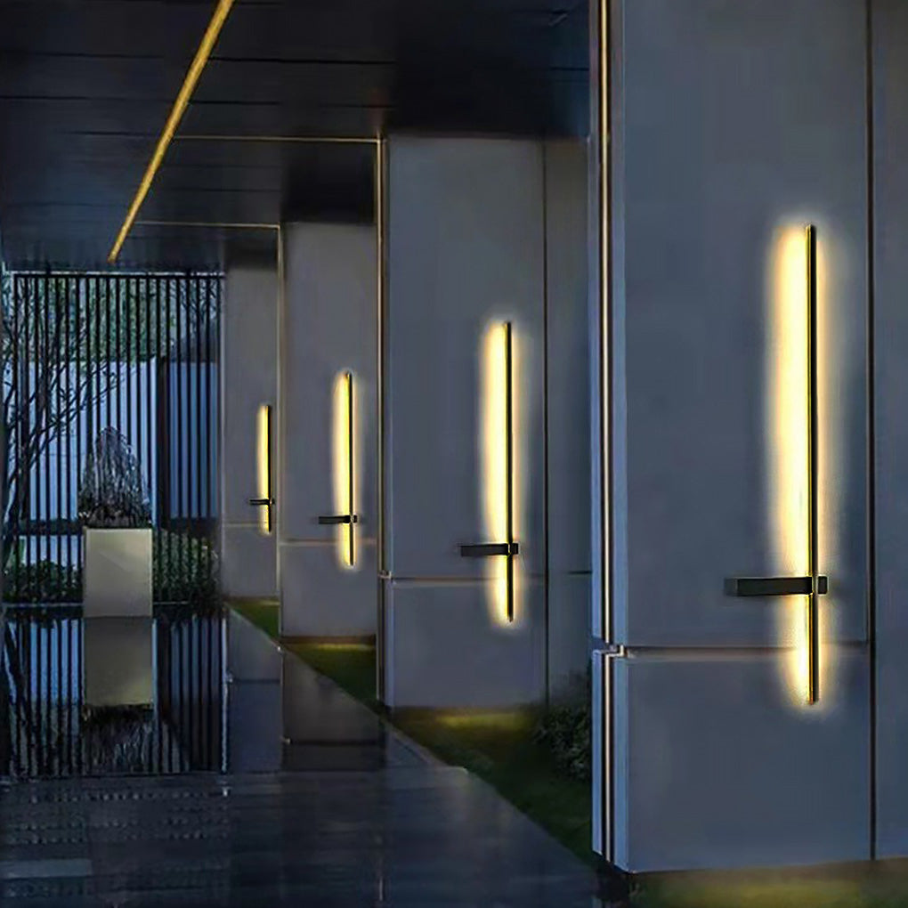 Interior application of Strip Wall Lighting along a modern hallway wall, providing vertical accent lighting with a sleek black mounting bar.