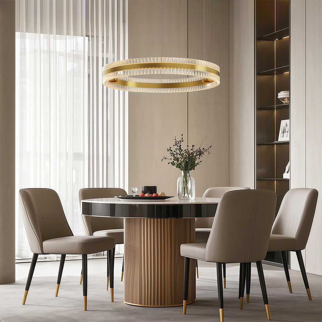 Stylish modern circular chandelier with a gold finish, hanging in a modern interior.