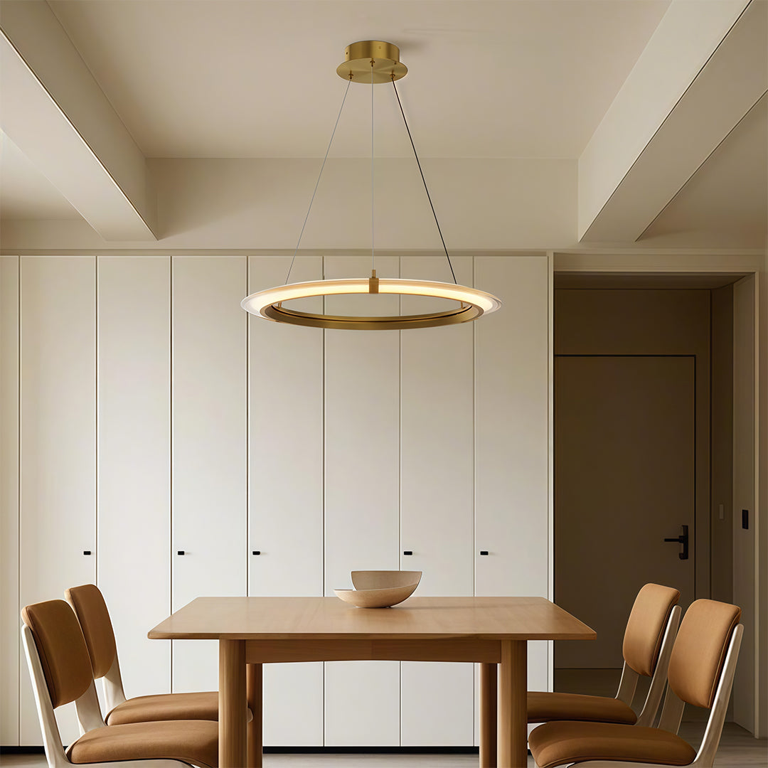 Stylish modern round chandelier with a gold finish, enhancing a modern kitchen and dining space.