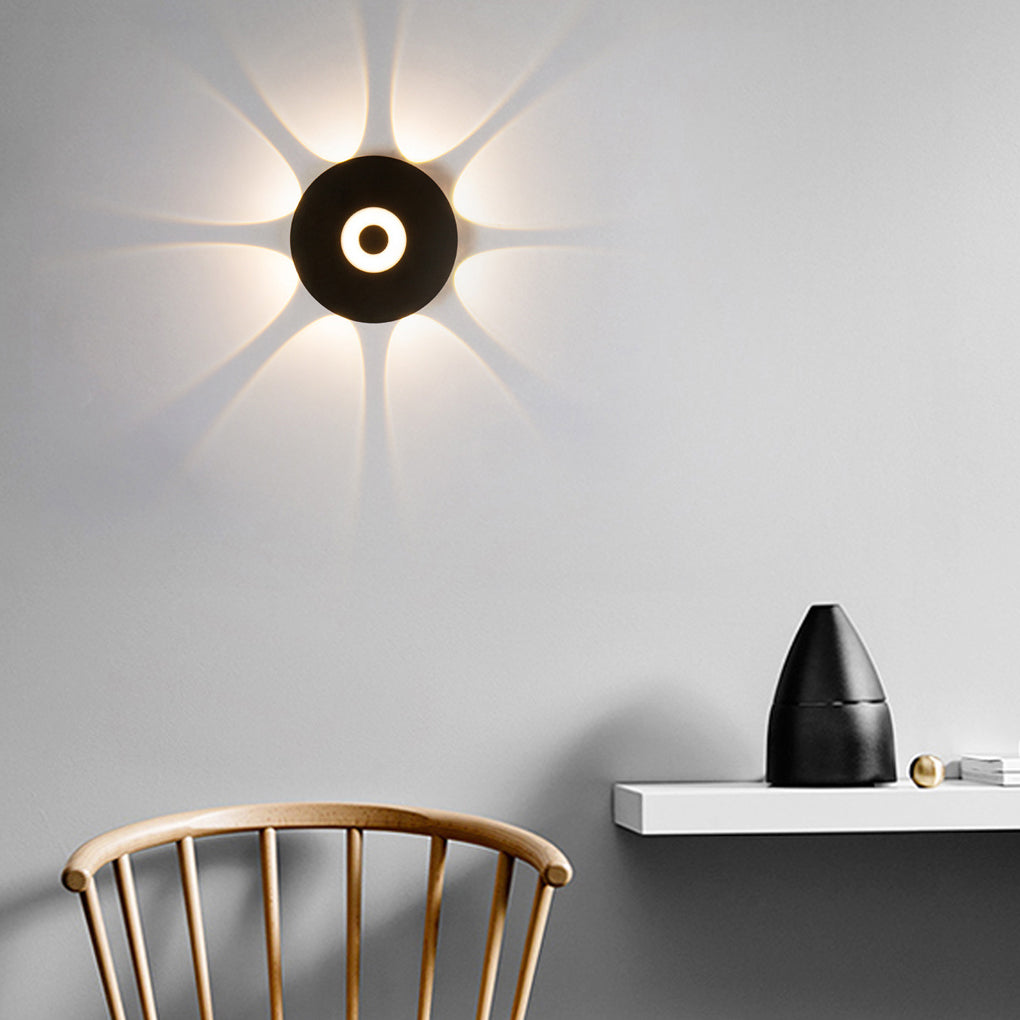 Sunflower LED wall light displayed on a blue wall, showcasing decorative design.