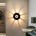 Sunflower LED wall light enhancing an outdoor wall with ambient, decorative lighting.
