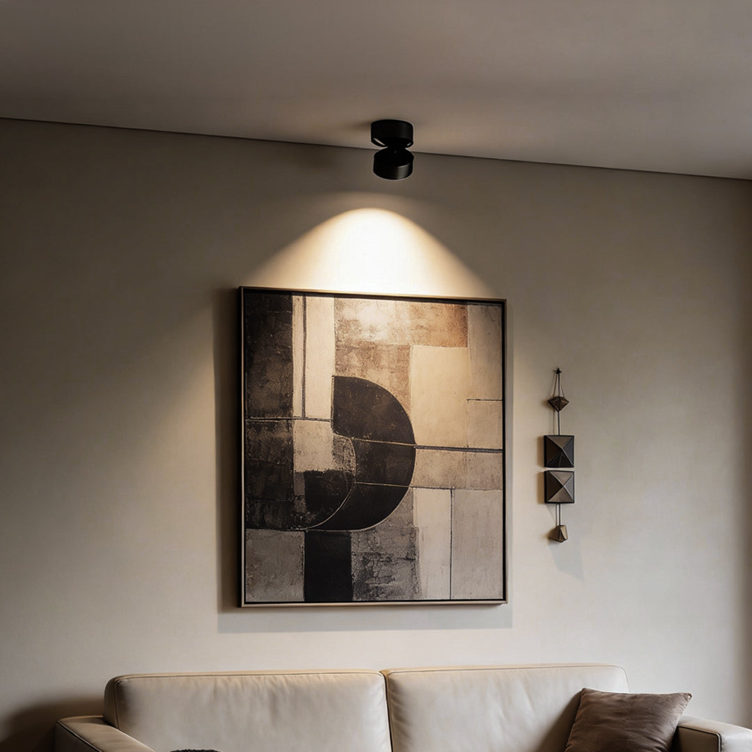 Surface mounted adjustable spotlight providing ambient light in a modern bedroom setting.