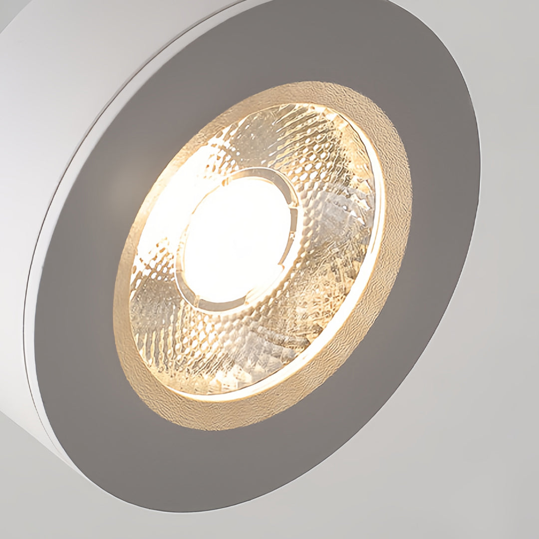 Surface mounted adjustable spotlight in white, highlighting its minimalist design and bright illumination.