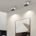 Surface mounted spot light installed in modern living room with minimalist decor.