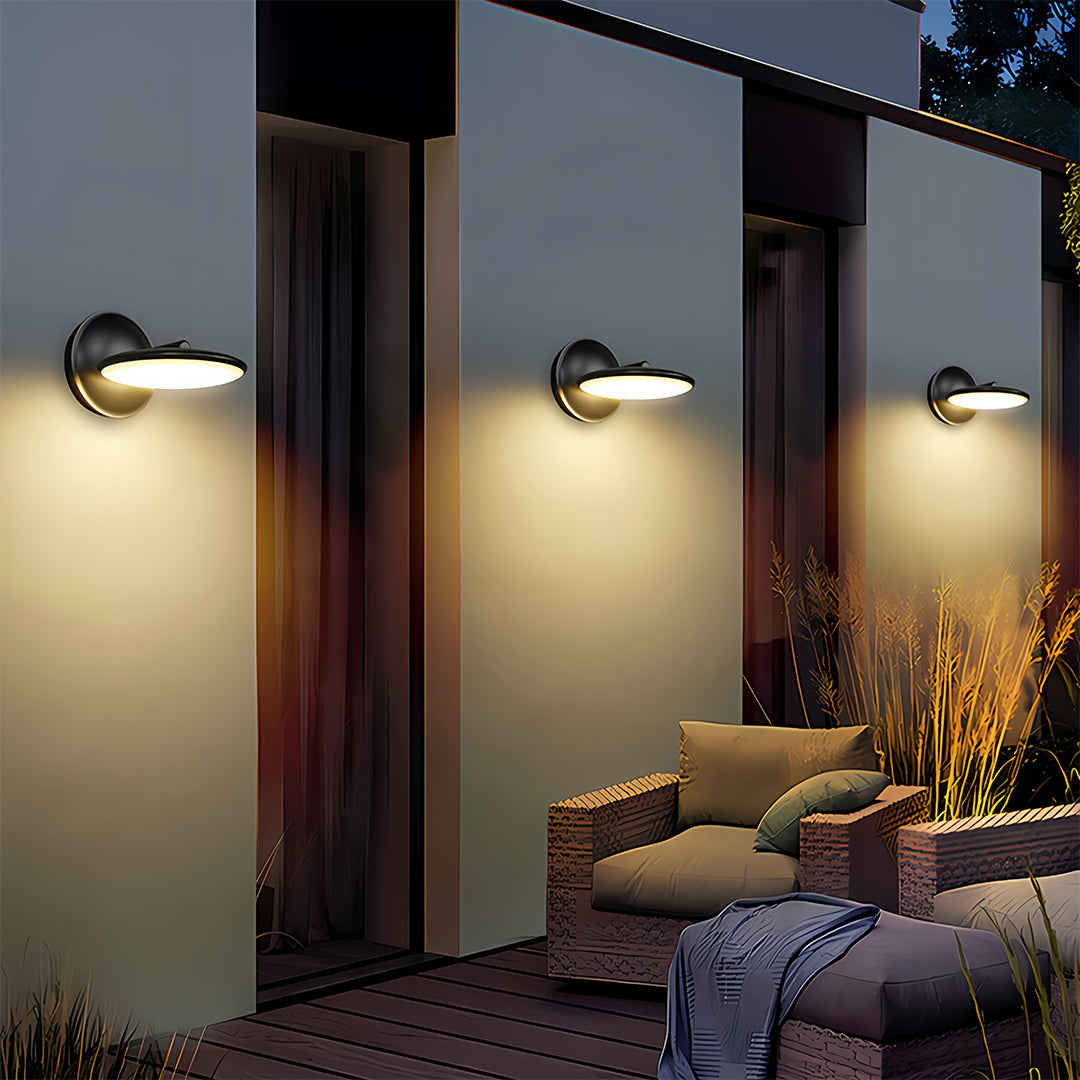 Multiple swivel wall lights illuminating contemporary patio with glass doors and evening ambiance