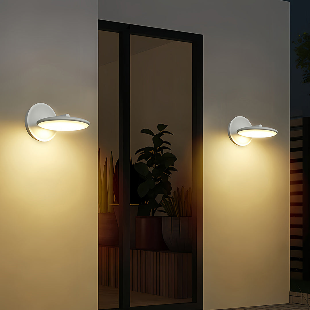 Row of swivel wall lights creating uniform illumination along modern building facade at twilight