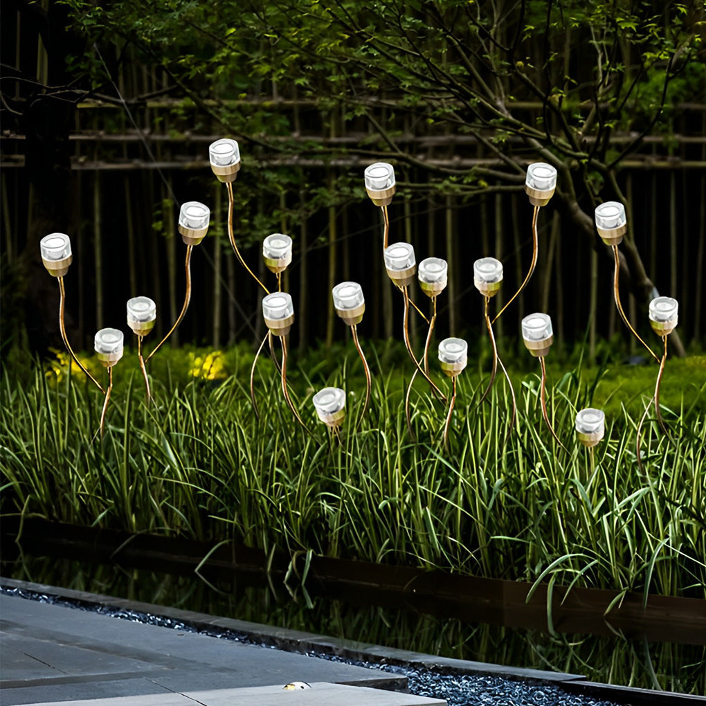 Syphasera standing lamp group installation creating rhythmic light points along a pathway at night.