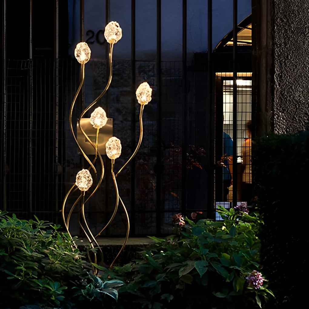 Syphasera standing lamp cluster forming sculptural light accents near a modern glass facade.