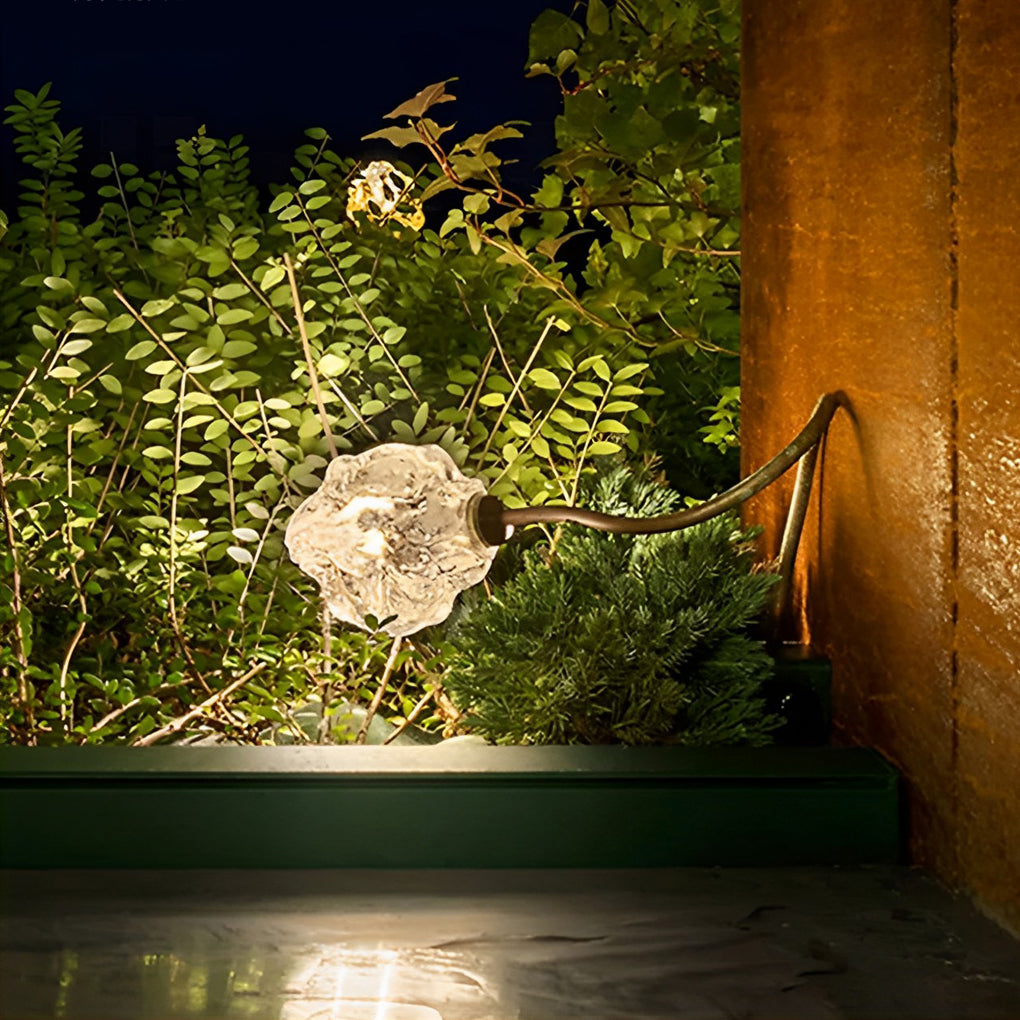 Syphasera standing lamp single piece accenting a stone wall with warm reflected light.