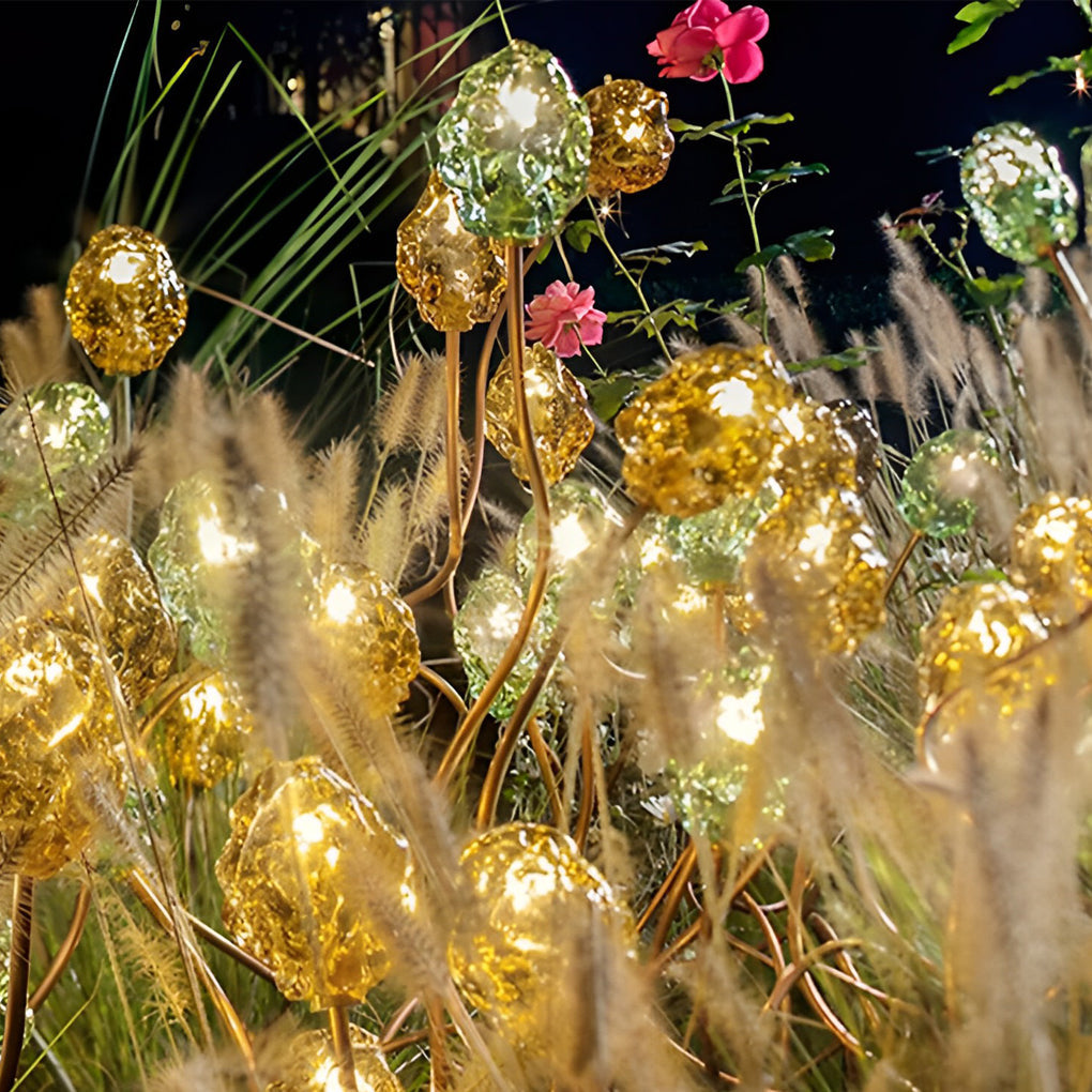 Syphasera standing lamp glowing in tall grass creating a magical outdoor lighting atmosphere.