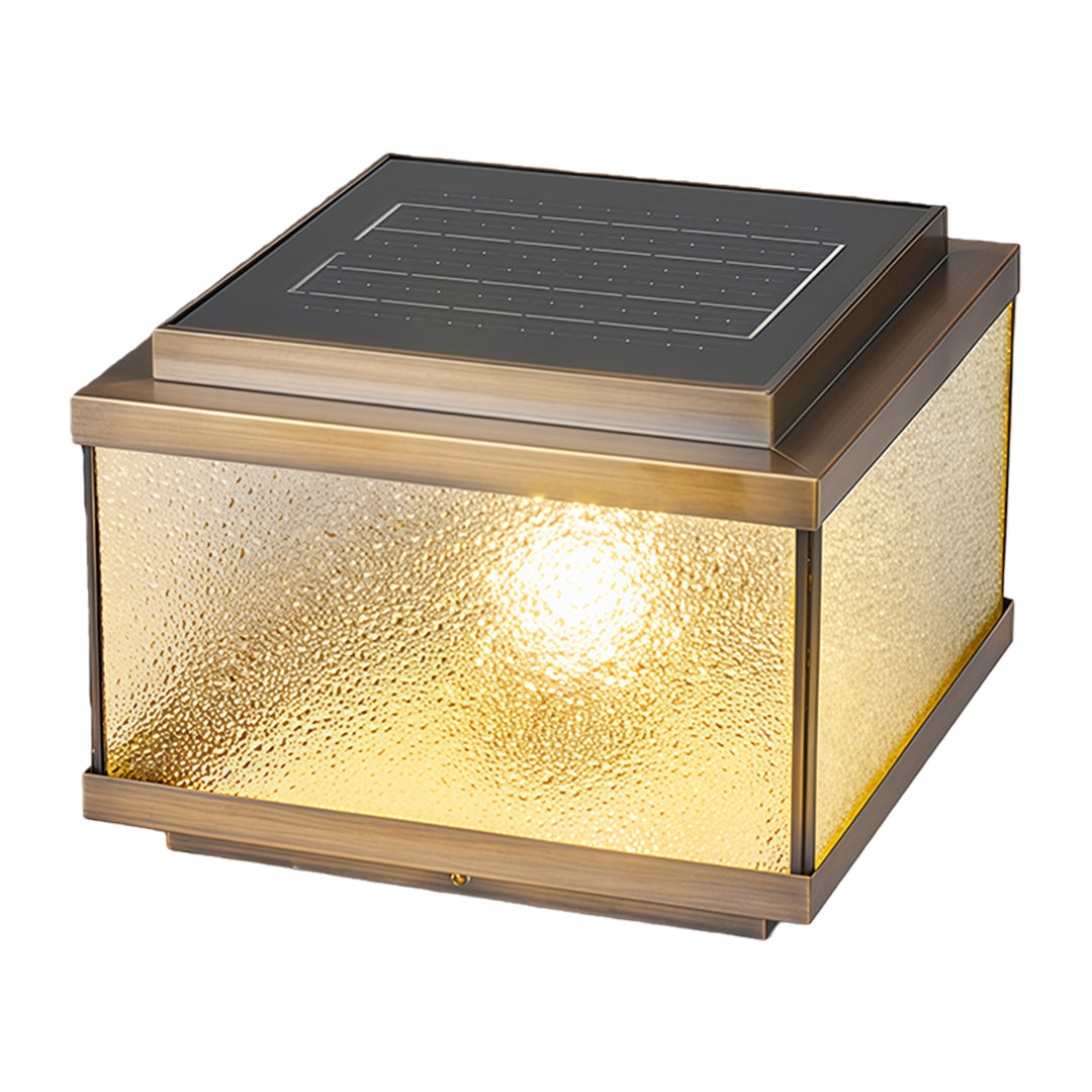 Decorative garden pillar light with textured glass panels emitting warm ambient outdoor lighting.
