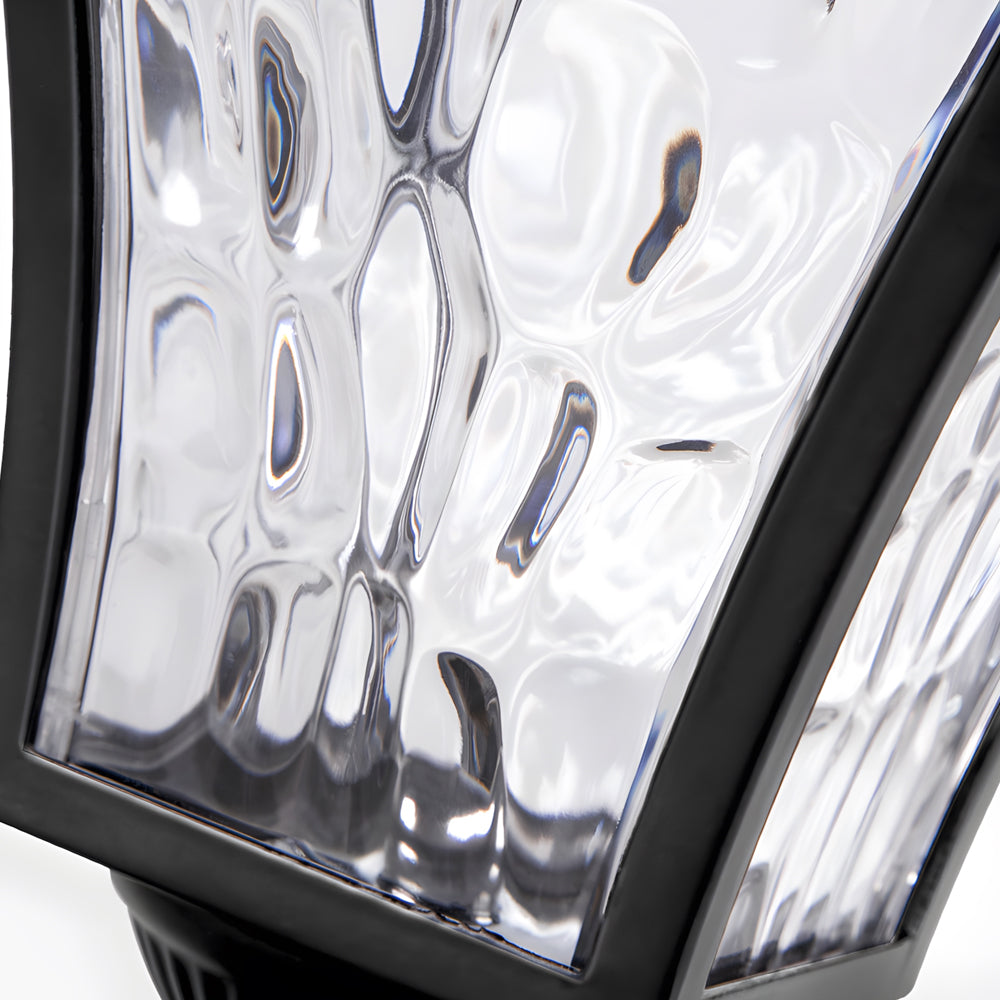 Close-up detail of textured glass panel showing water droplet pattern design on outdoor light fixture