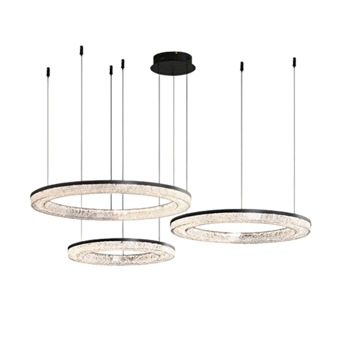 Three circle pendant light with a metallic frame, providing sophisticated lighting in a minimalist living room.