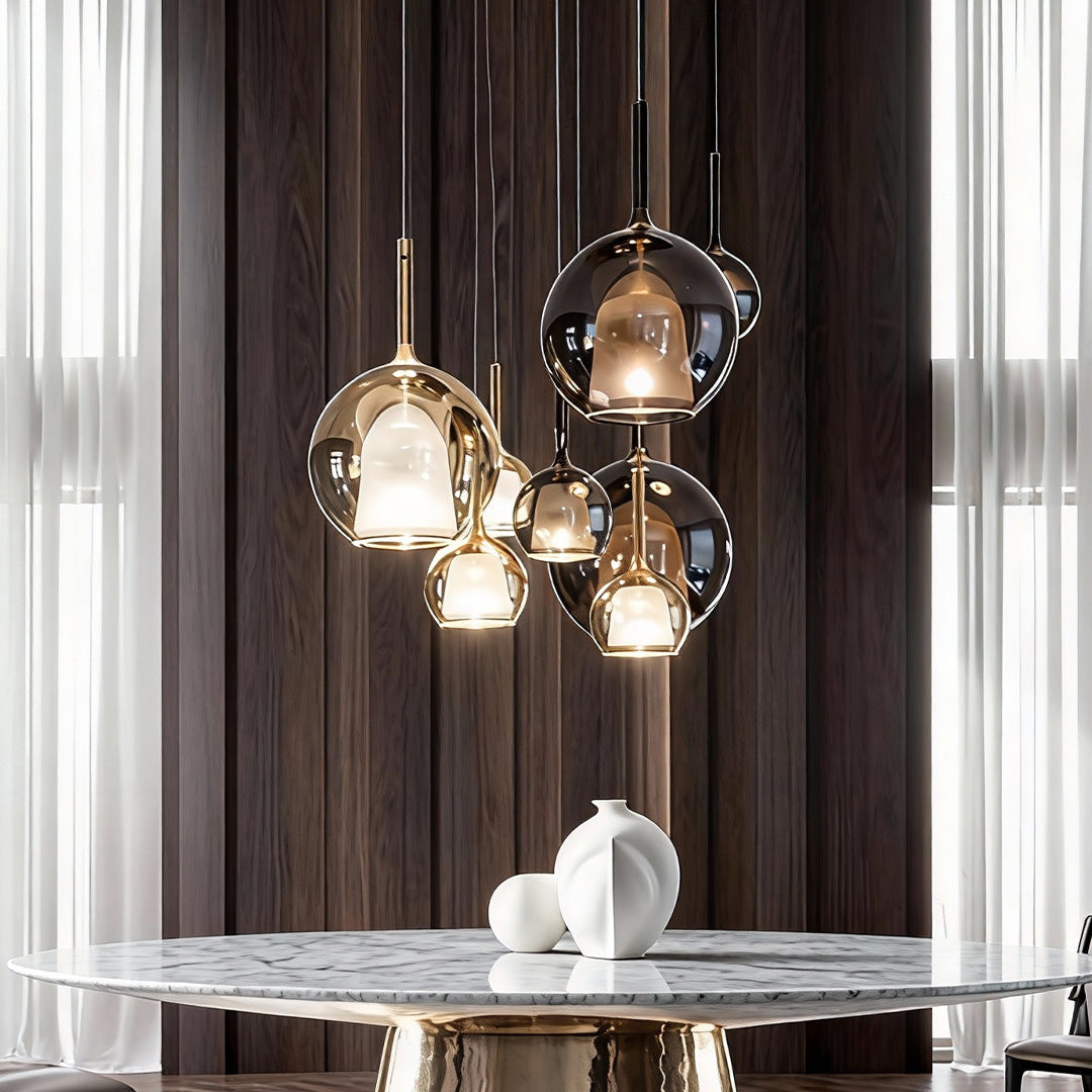 Three glass ball pendant lights hanging above a dining table, adding sophistication to a modern interior.