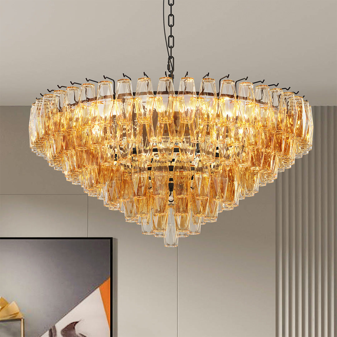 Round gold glass pendant chandelier with tiered crystal drops in a modern beige interior.