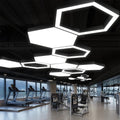 Top-down view of a geometric modern chandelier with sharp lines, illuminating an industrial-style room.