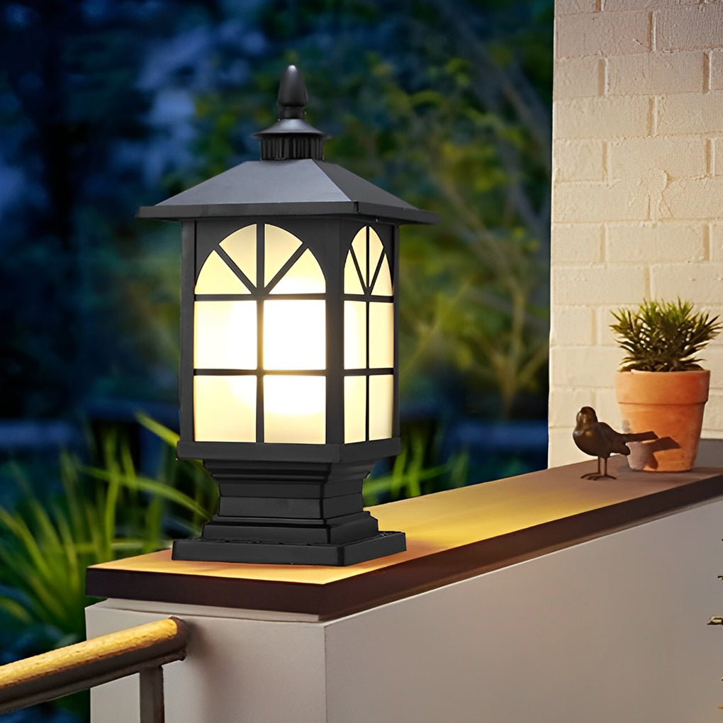 Traditional outdoor street light pillar mounted on fence wall with warm glow.