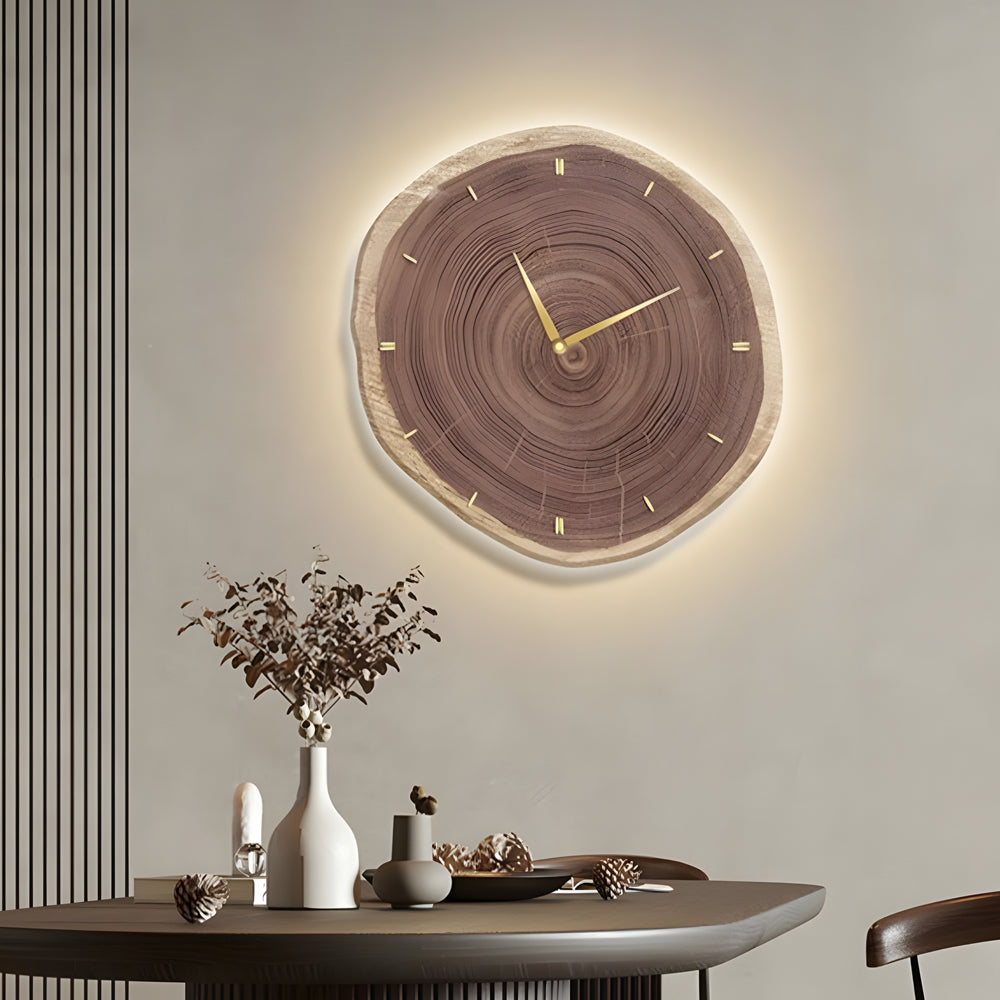 Minimalistic tree stump wall clock with soft light around the edges, enhancing the room's rustic charm and elegance.