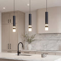 Trio of sleek Black LED Cylinder Pendant lights over a modern marble kitchen island setup.