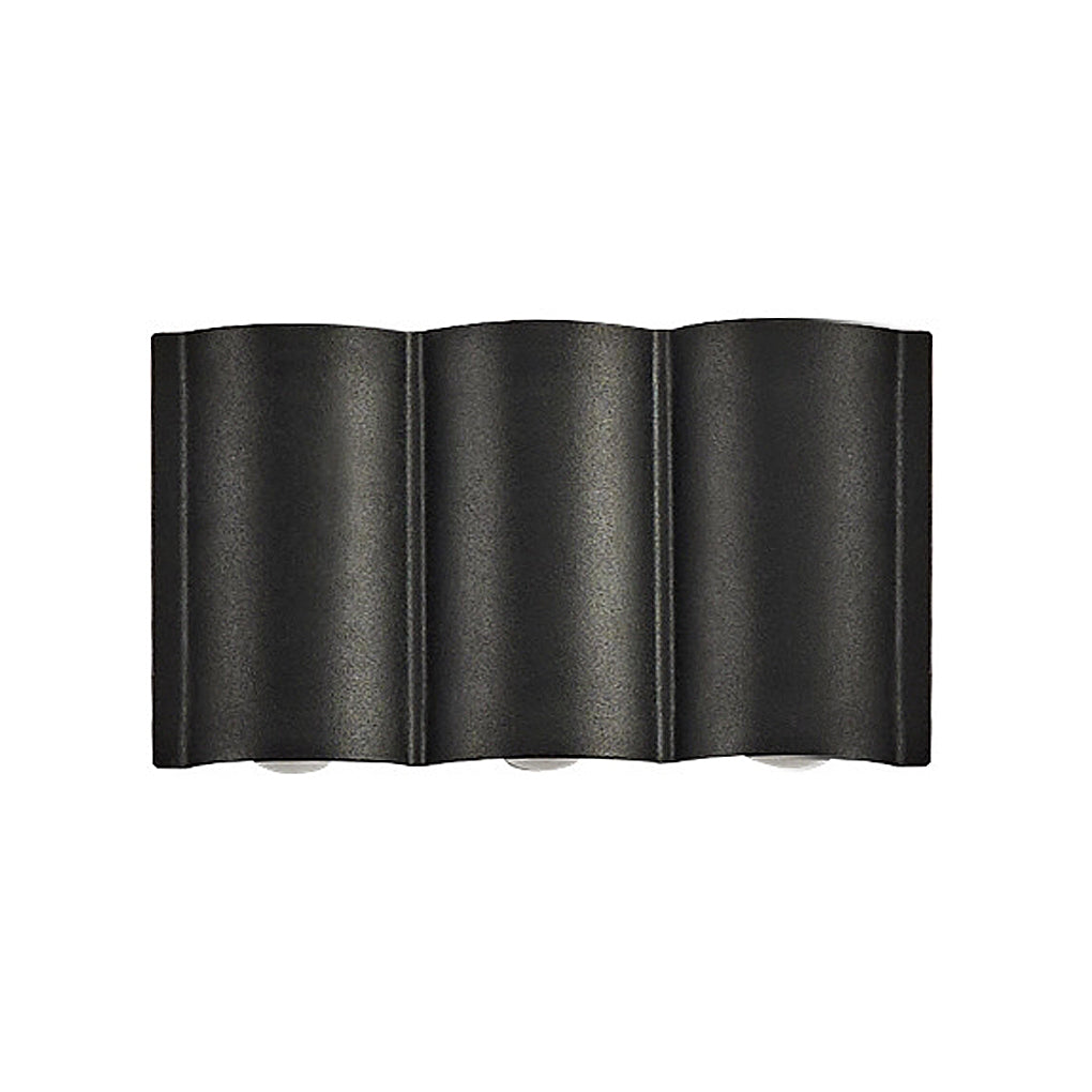 Triple black up and down outdoor wall lights providing layered illumination on modern exterior wall.