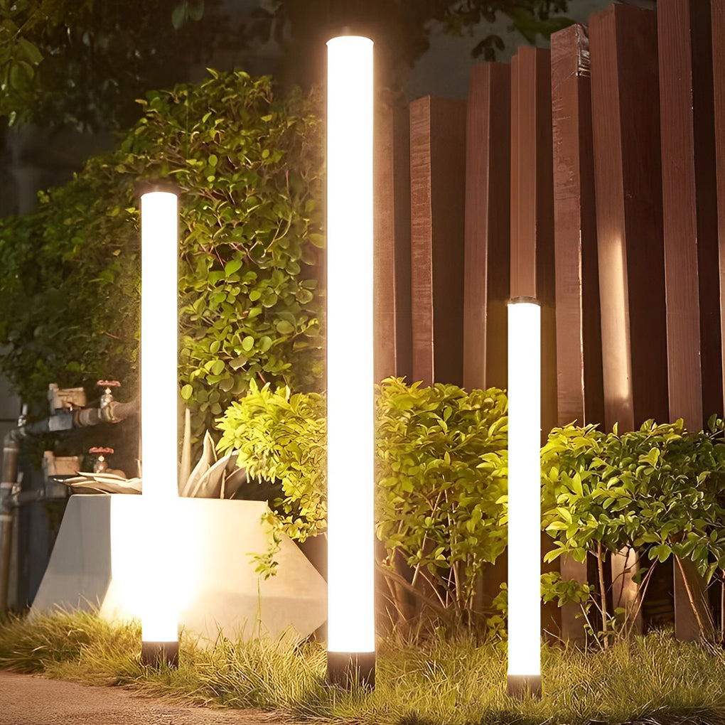 Tube landscape light beside a modern house, creating a sleek and contemporary outdoor look.
