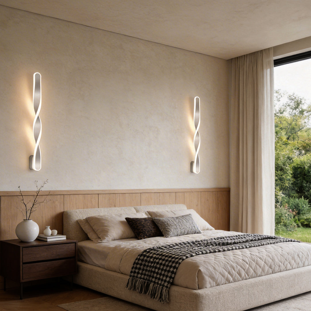 Twisted LED wall lights providing ambient illumination in a contemporary bedroom.