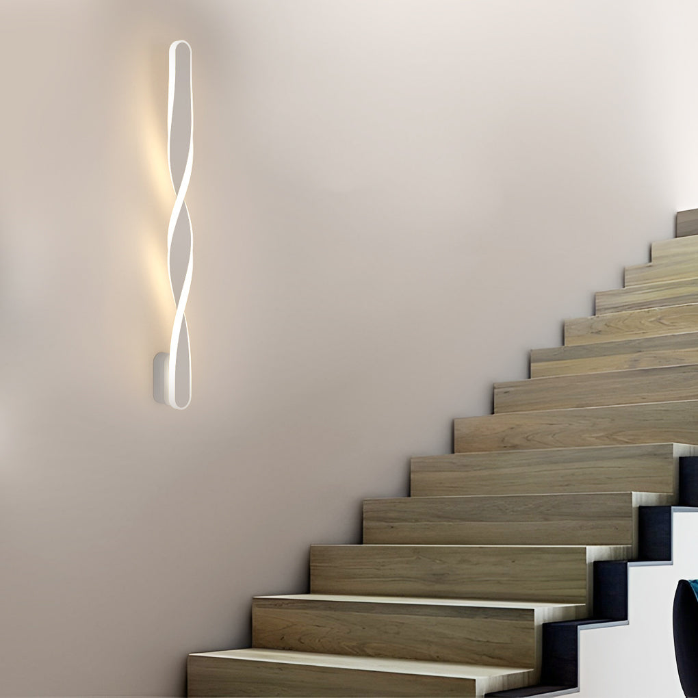 Twisted LED wall lights with a black and white finish, enhancing a modern interior.