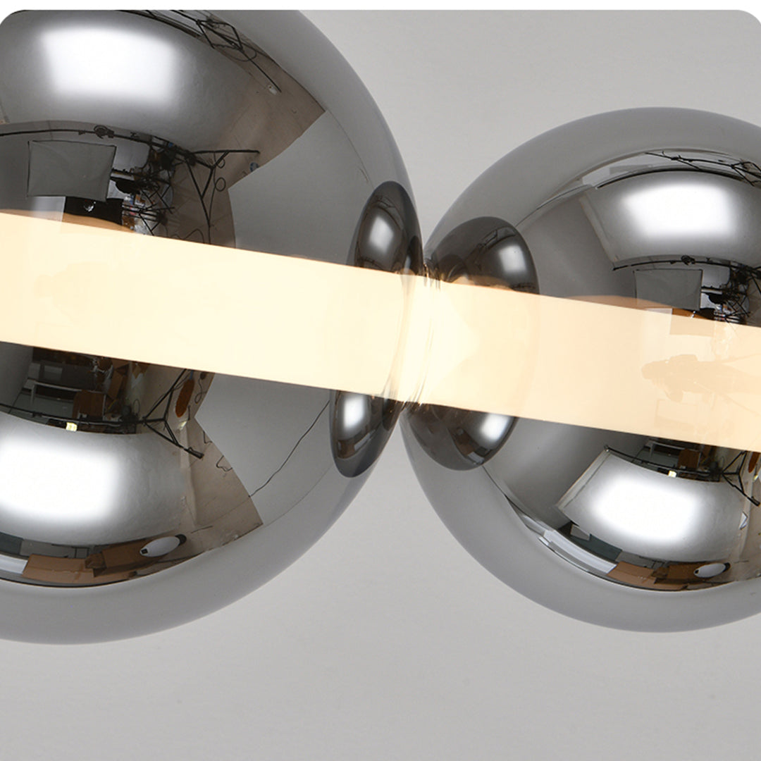 Two silver round globe in different sizes touching each other