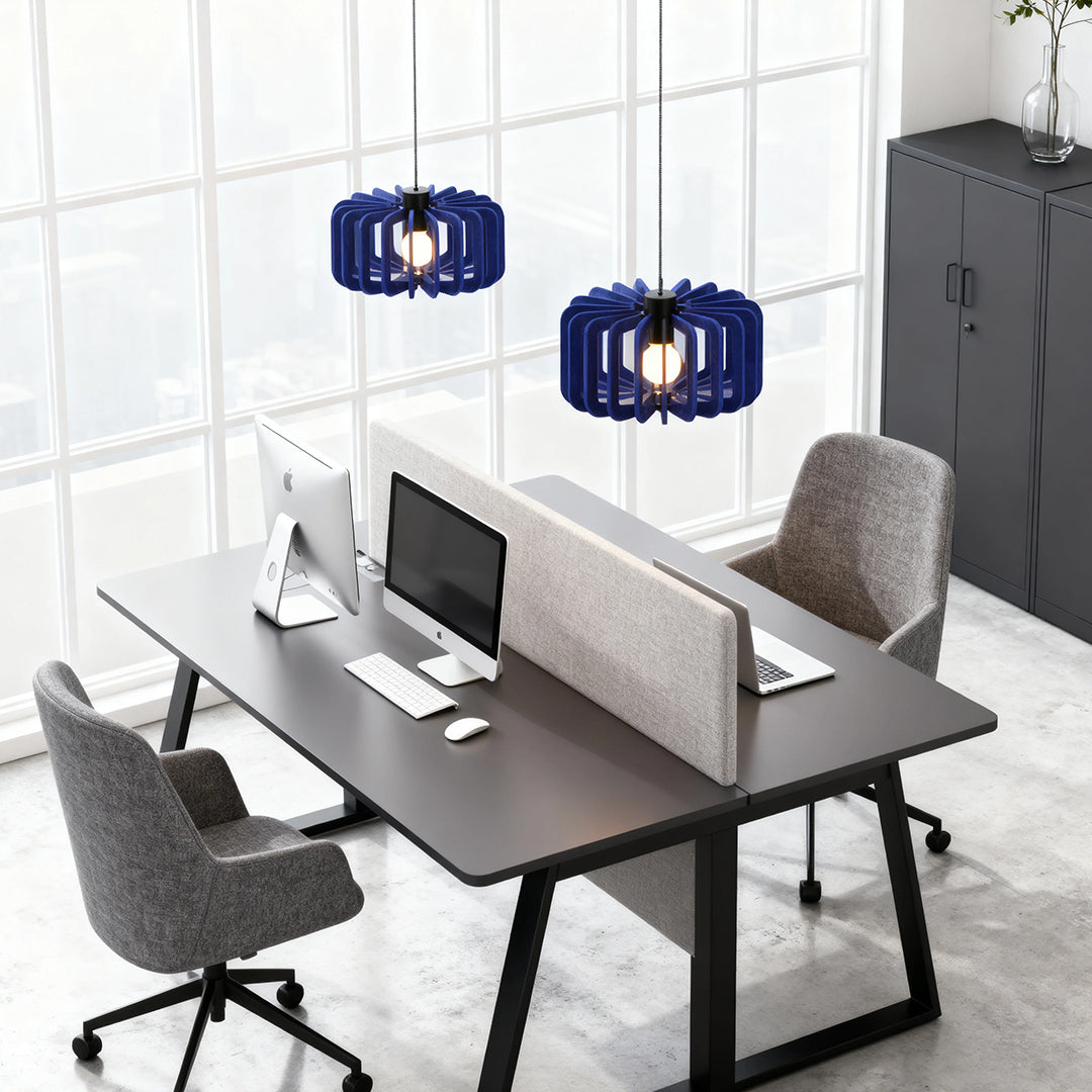 Two navy blue wooden Nordic pendant lights hanging above a contemporary open-plan office desk.