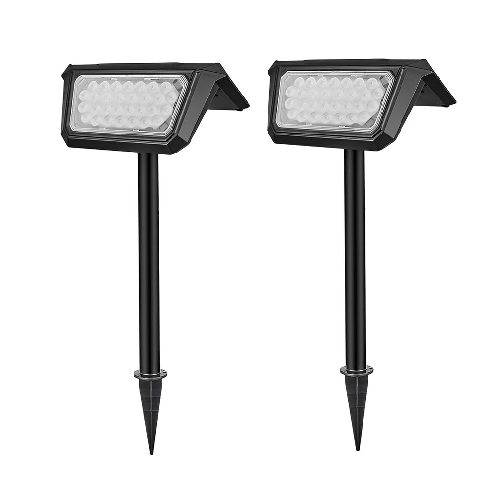 Two solar path lights outdoor with adjustable solar panels, ready for installation in a garden.