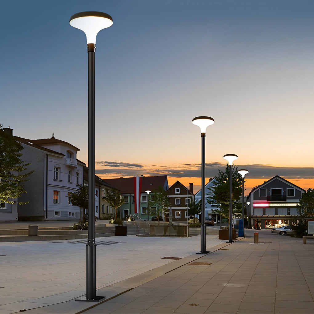 UFO solar street lights installed along an urban street at sunset.