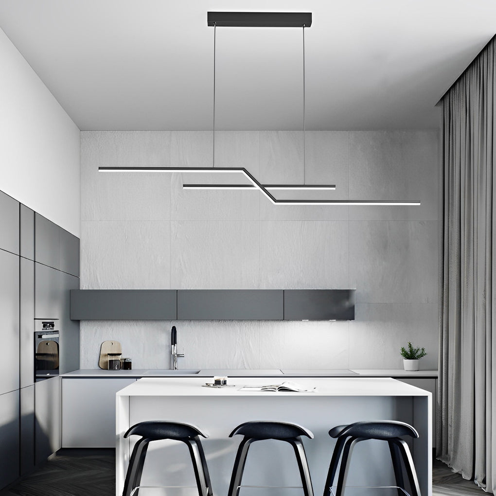 Unique pendant lighting with a minimalist black linear profile hanging over a bright white kitchen island.