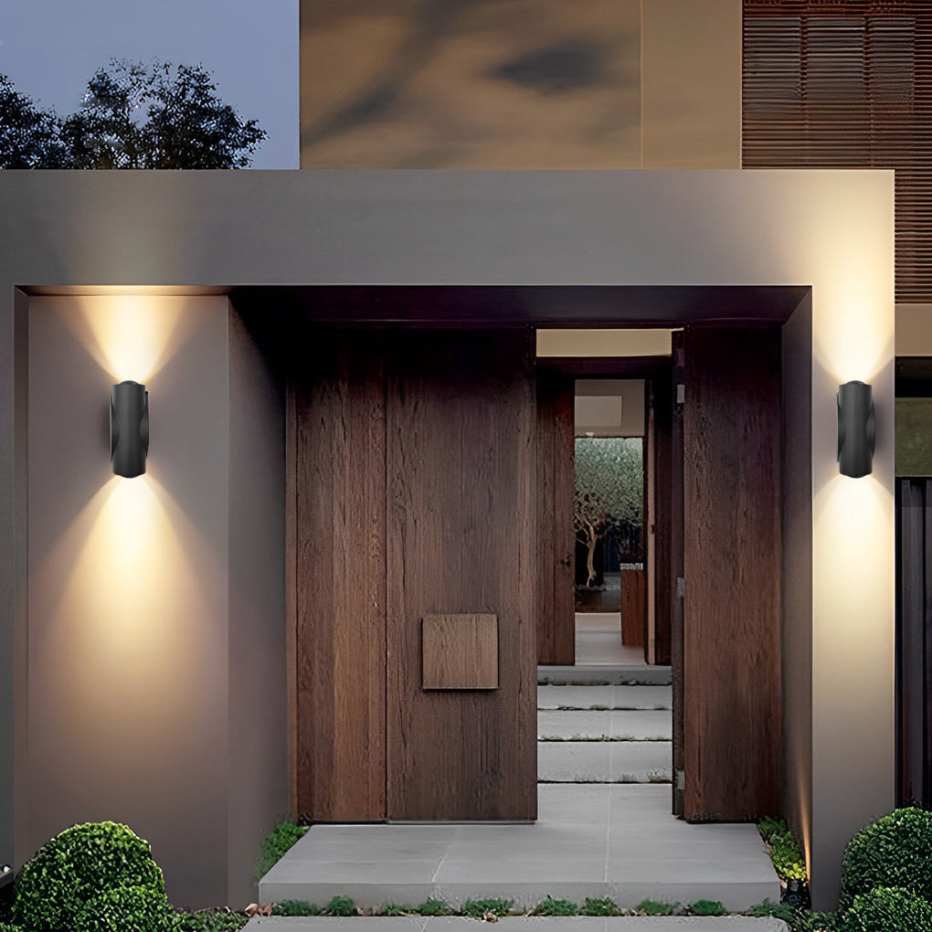 Up and down light wall sconce illuminating a minimalist exterior wall with focused glow.