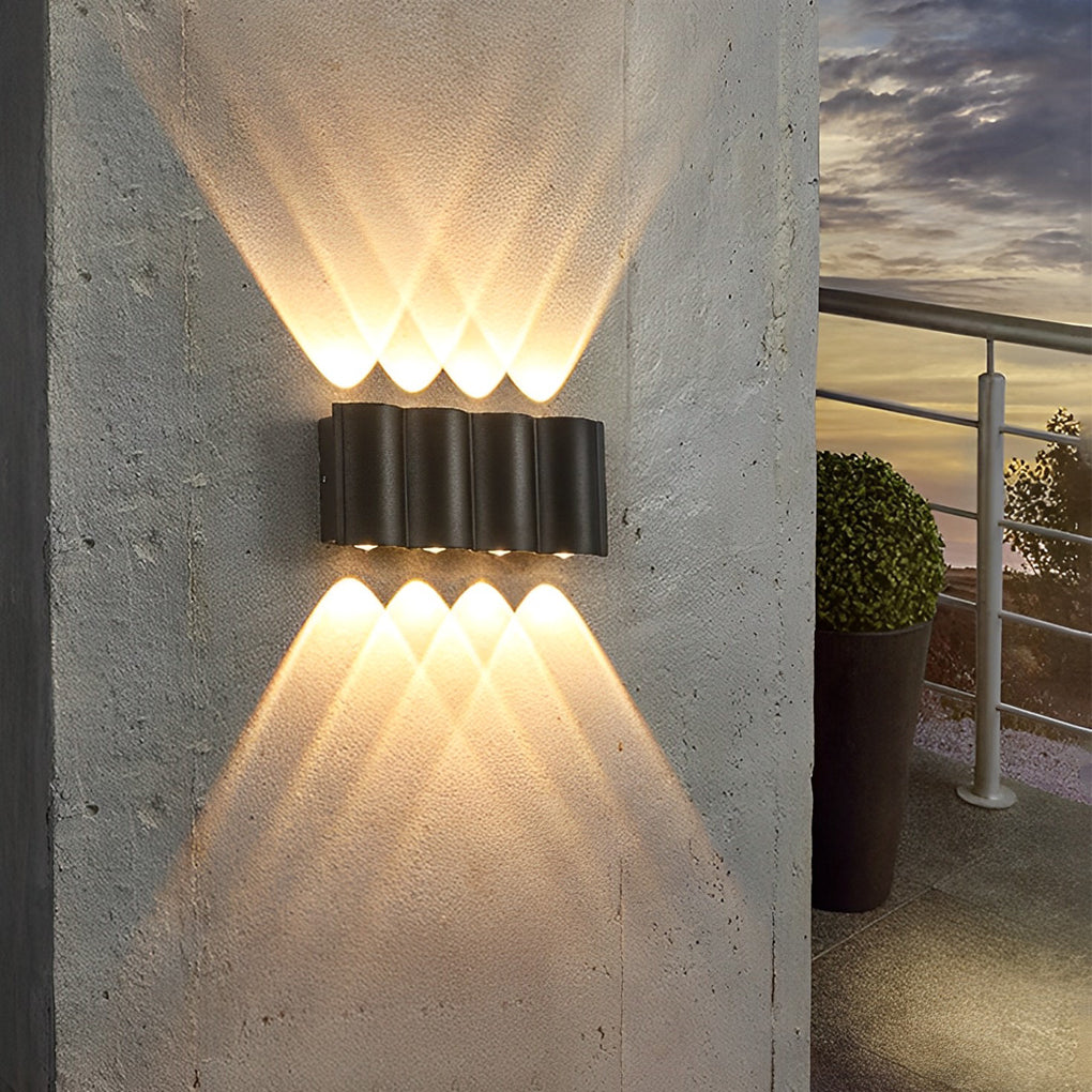 Up and down outdoor wall lights illuminating garden pathway with warm light for outdoor ambiance.
