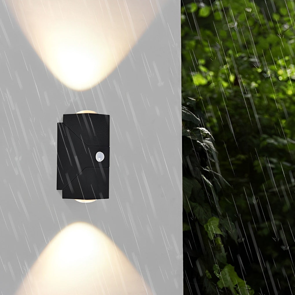 Up down sconce outdoor light fixture illuminating garden path and plants with focused beams for safety.
