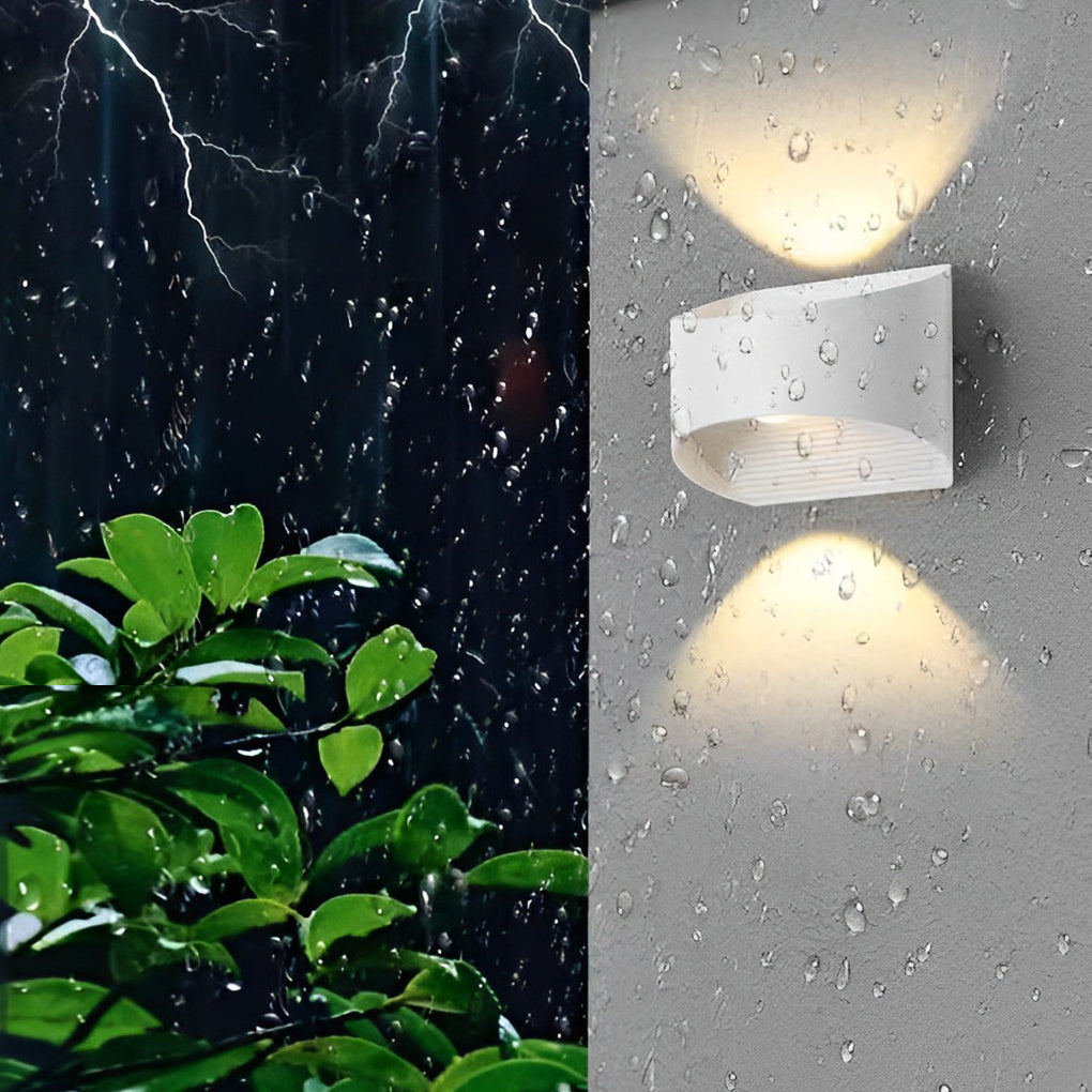 Up and down wall sconce lighting in a minimalist bedroom, casting soft light on the wall.