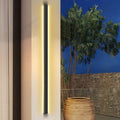 Long black outdoor lights with vertical LED strips, mounted on a modern exterior wall for sleek illumination.