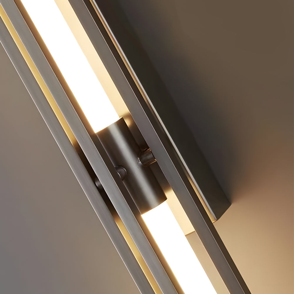 Front view of vertical tube wall sconce in gold finish on white background.