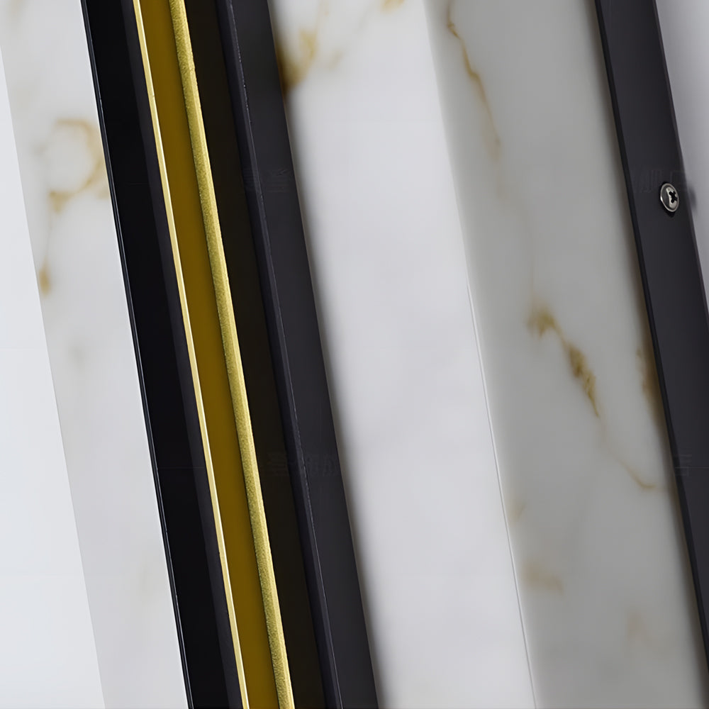 Close up detail of vertical wall light showing marble glass panel and metal frame construction.