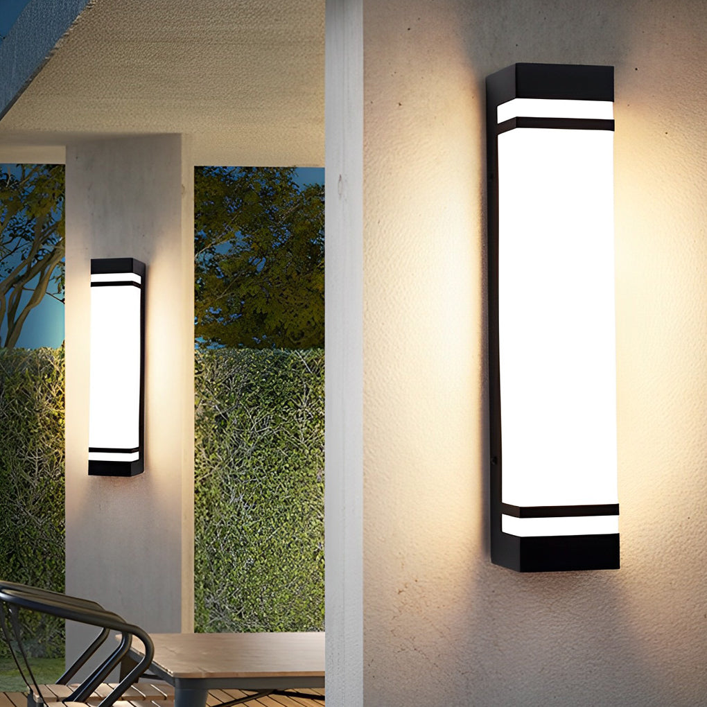 Vertical wall lighting fixture with a rectangular design, casting bright light on the wall.