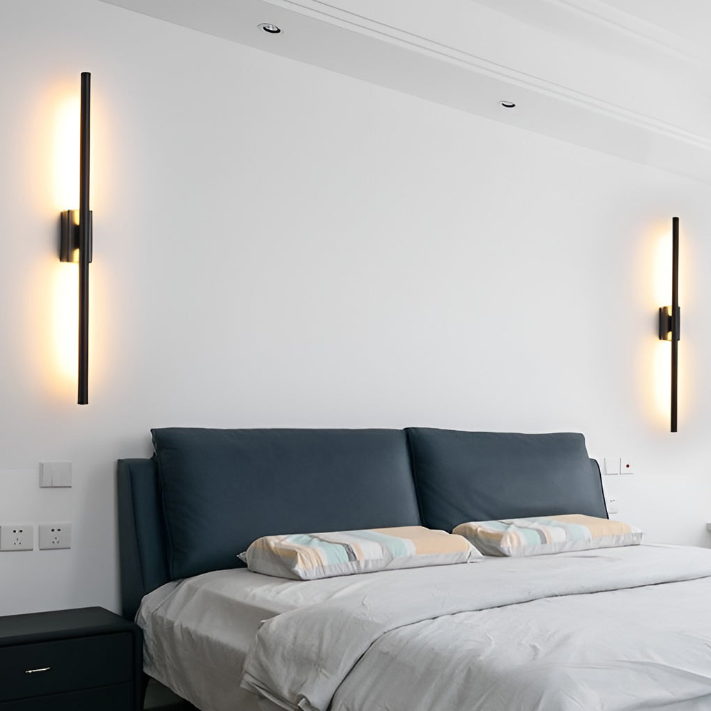 Vertical wall lights with detailed view of its gold and black finish.