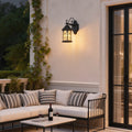 Vintage bronze classic porch light with decorative scroll arm and frosted glass panels for outdoor ambiance.