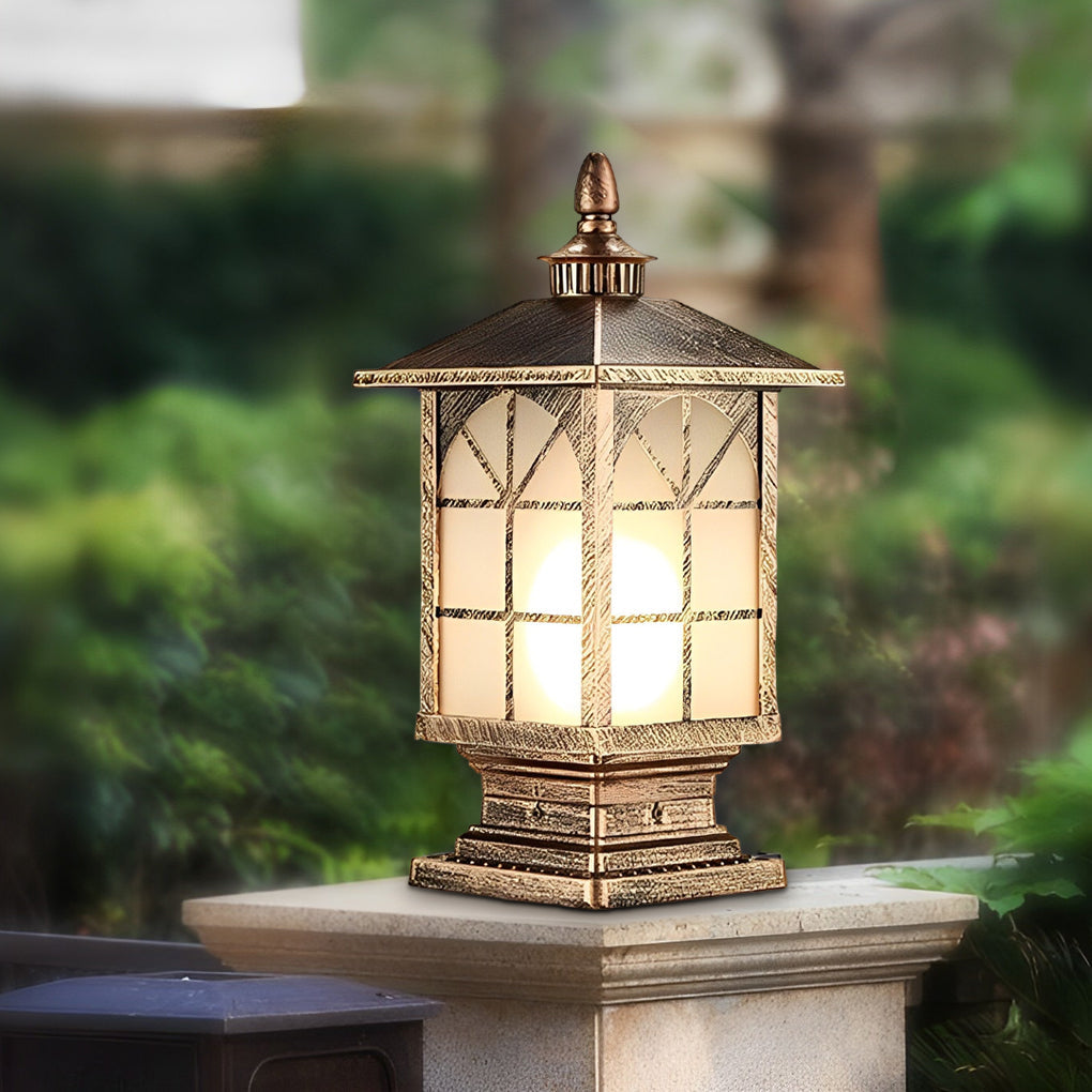 Vintage-style bronze street light pillar on stone base in garden setting.