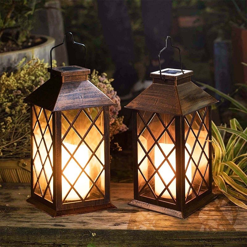 Vintage garden lanterns casting a gentle light in a backyard with greenery.