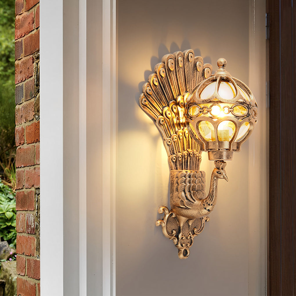 Vintage peacock wall sconce casting decorative light on brick wall.