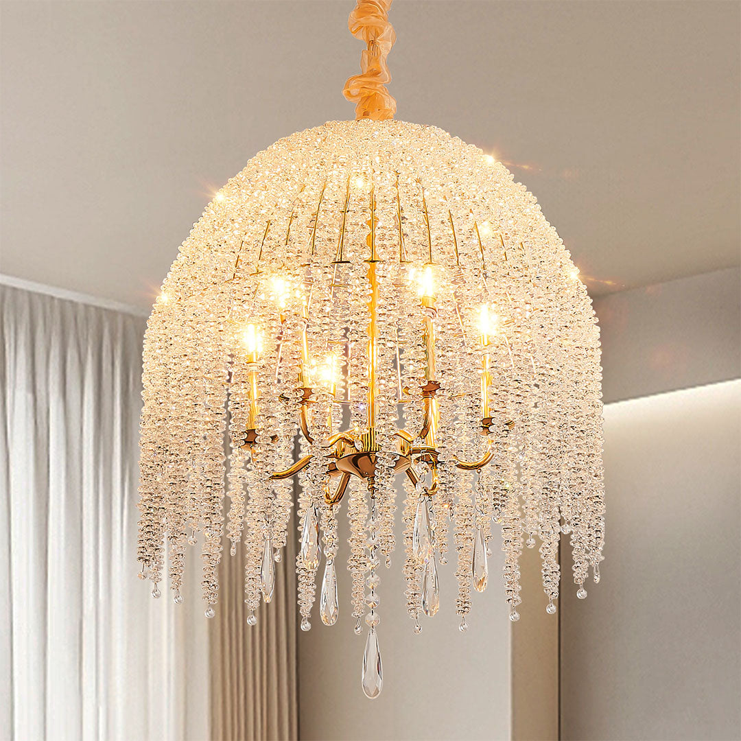 Gold teardrop crystal chandelier with multiple bulbs, reflecting classic elegance and modern charm.