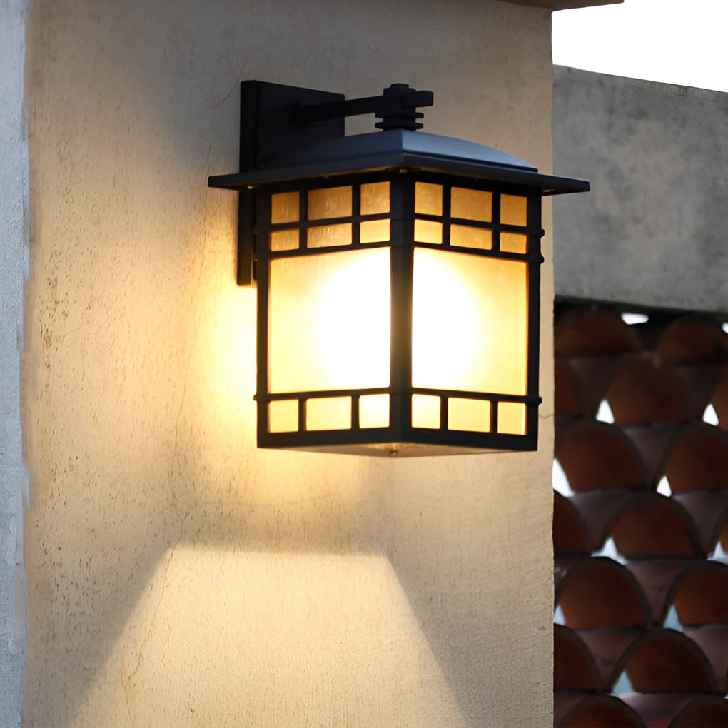 Vintage wall lantern with a close-up of its glass panels and warm glow.